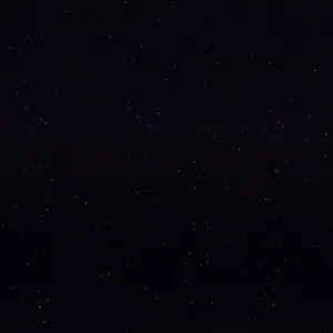 A starry night sky filled with numerous tiny white stars scattered across a deep black background.