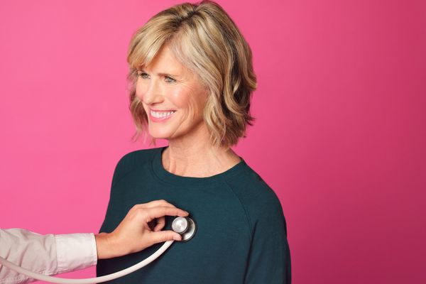 Woman having her heart listened to