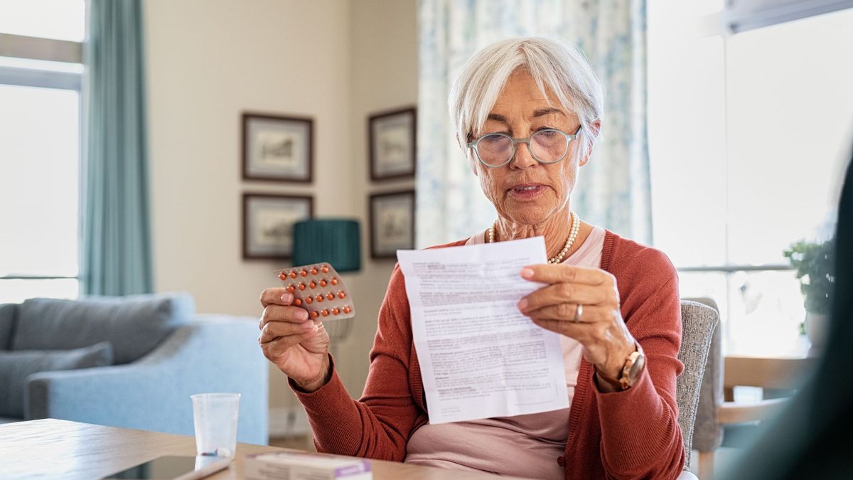 Woman over 60 reading medication information