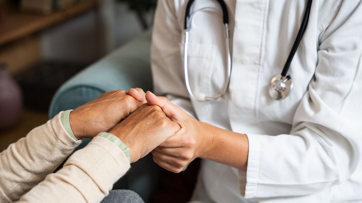 Provider holding woman's hands