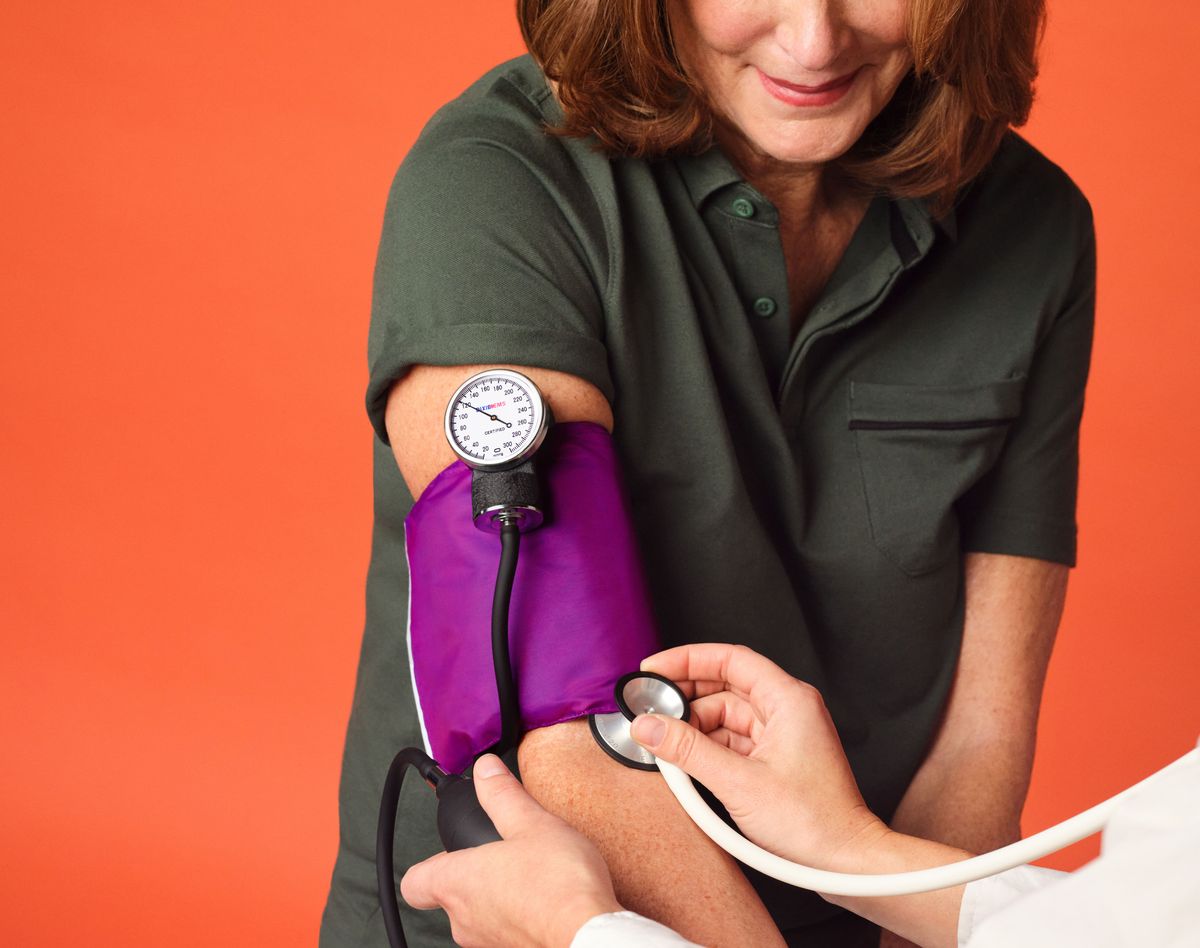 Woman 60+ having her blood pressure checked