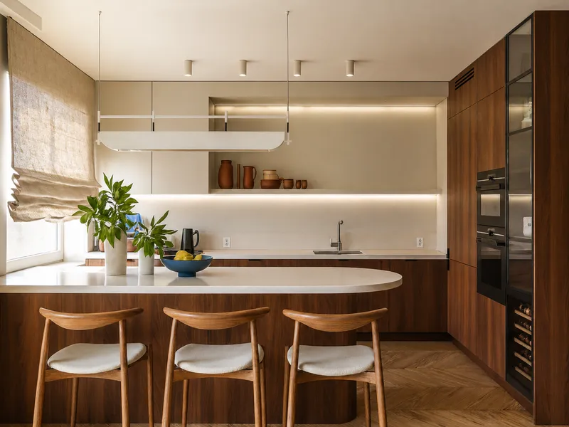Kitchen with dark wood cabinets, light stone countertop, herringbone flooring