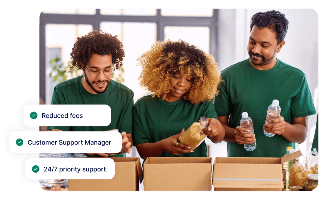 Three people in green shirts pack food items into boxes. Overlay text reads: "Reduced fees, Customer Support Manager, 24/7 priority support."