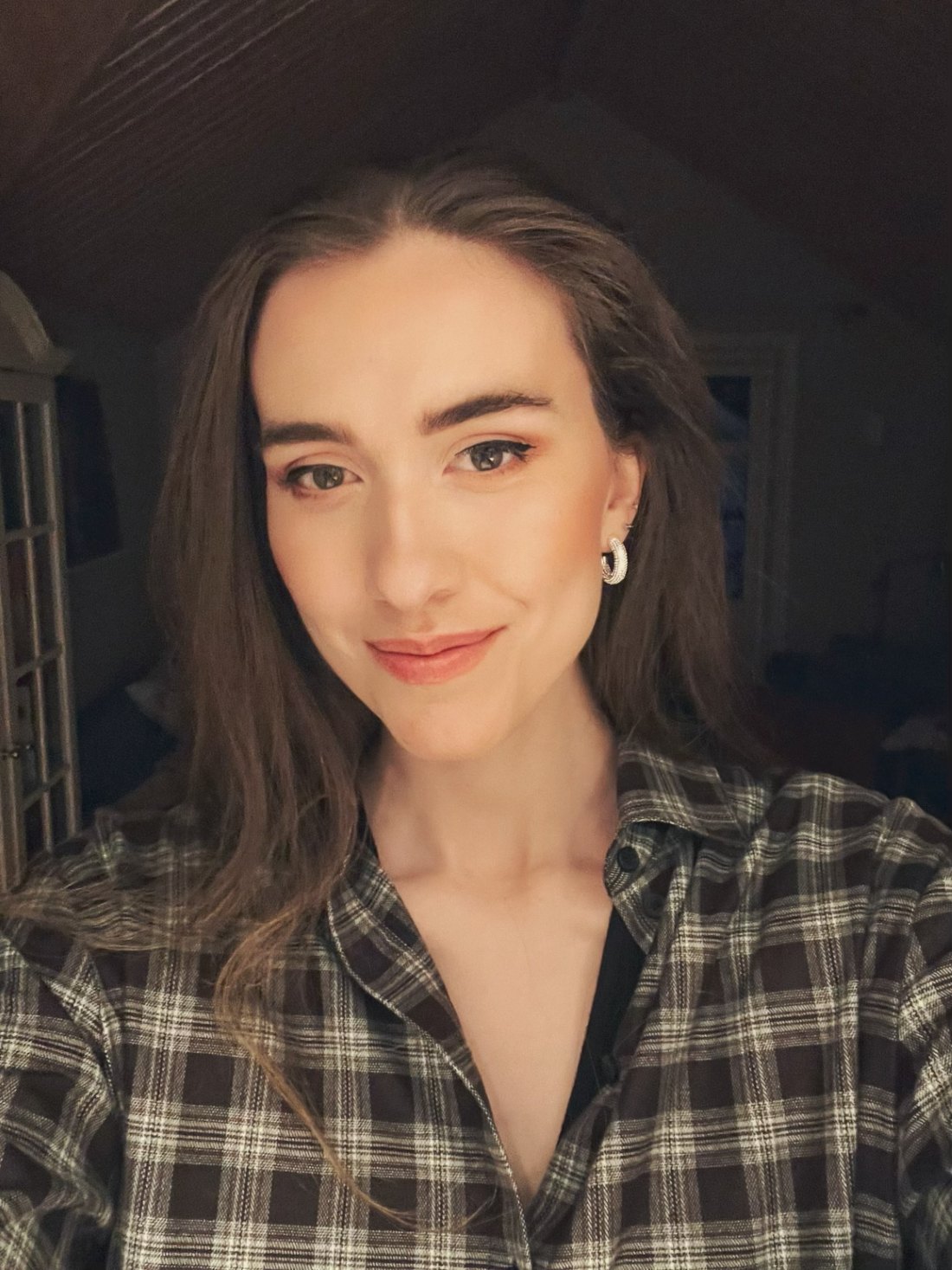 Eve Matsdotter smiling, with long brown hair and a checked shirt