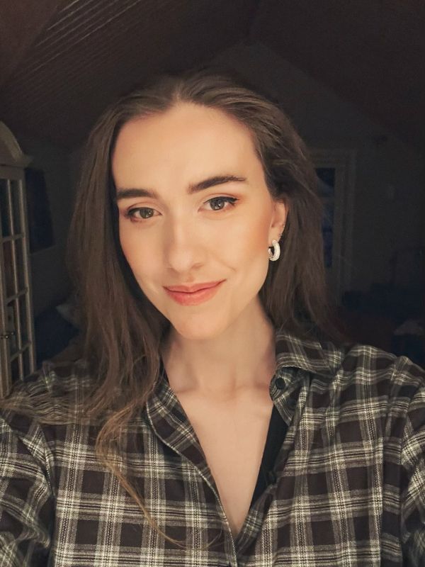 Eve Matsdotter smiling, with long brown hair and a checked shirt