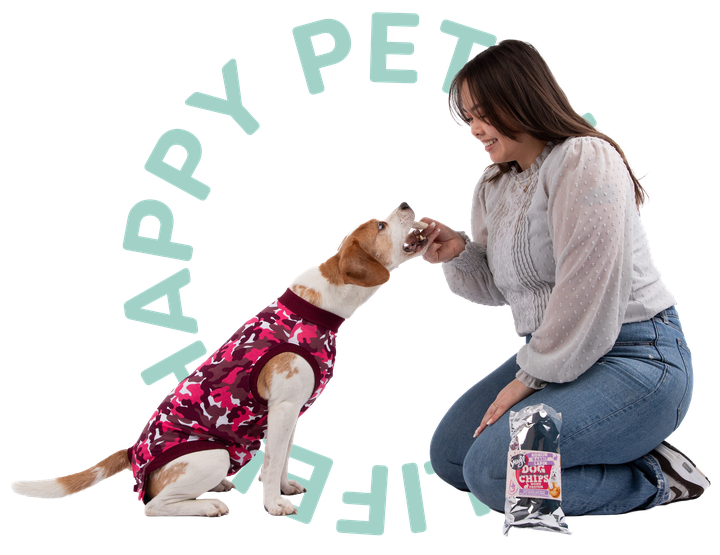 Woman kneeling and feeding treat to a dog in a pink camo vest, with "Happy Pet Life" text in the background.