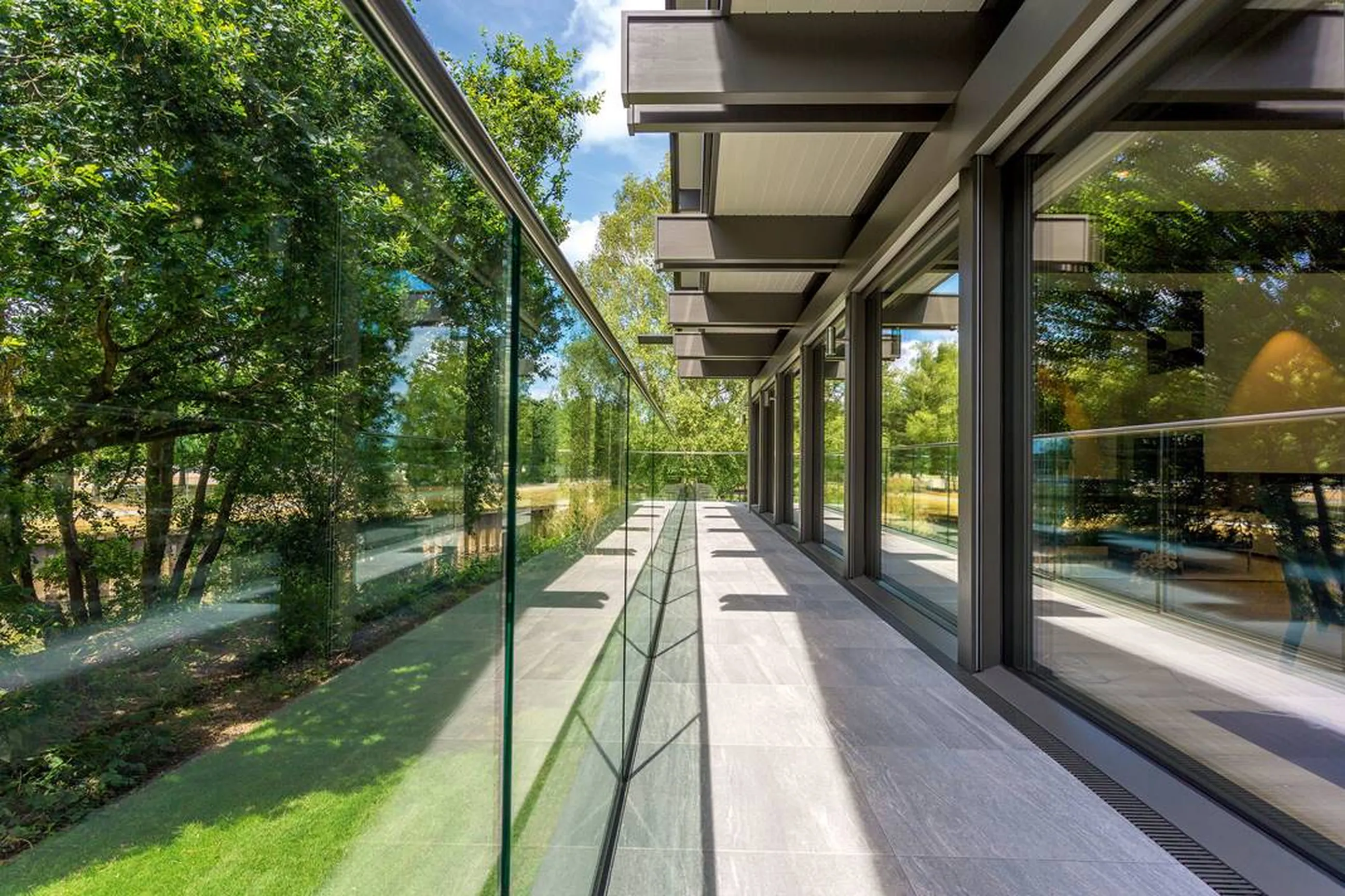 Glass balcony overlooking lush trees
