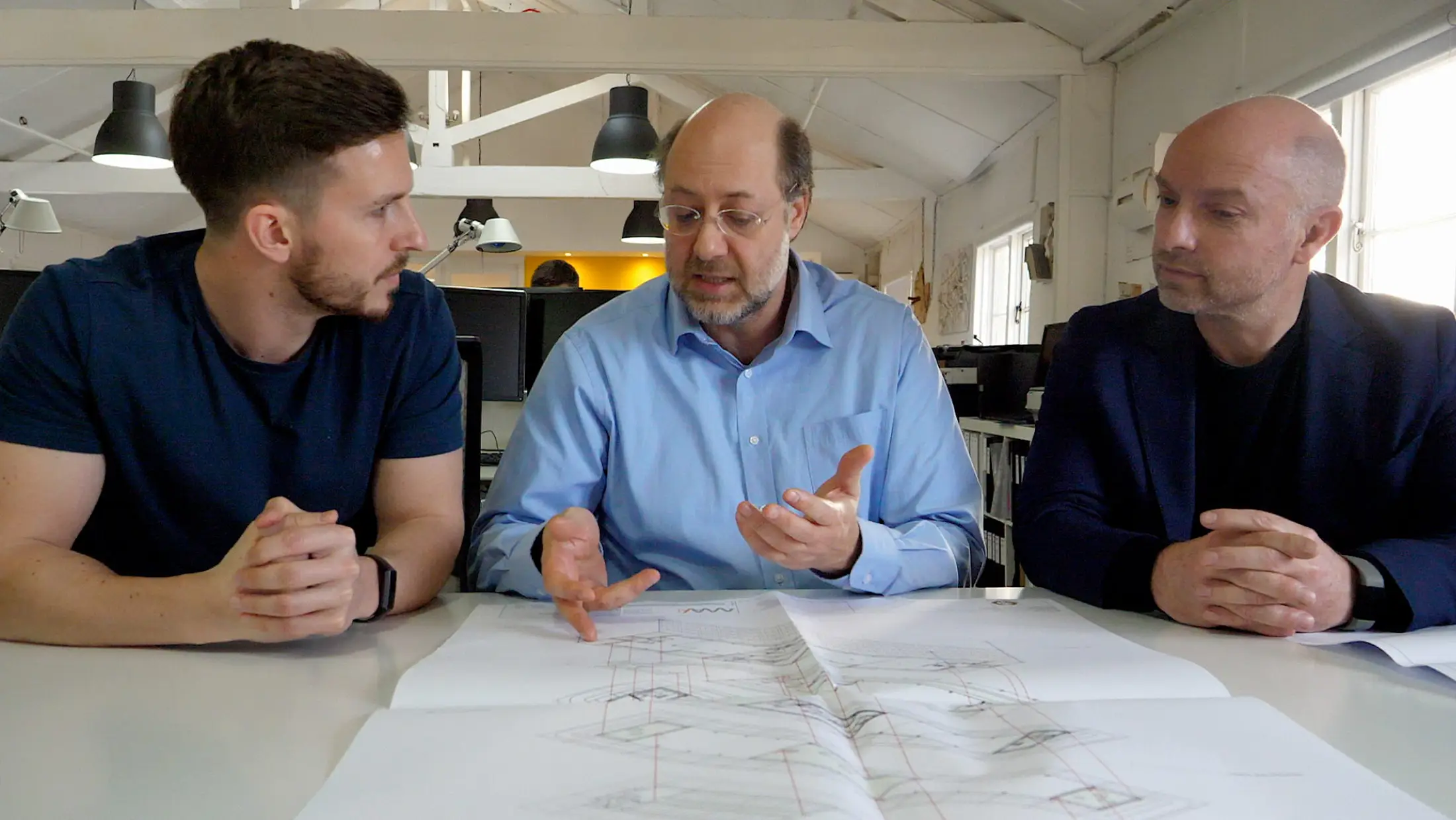 Three men in a meeting
