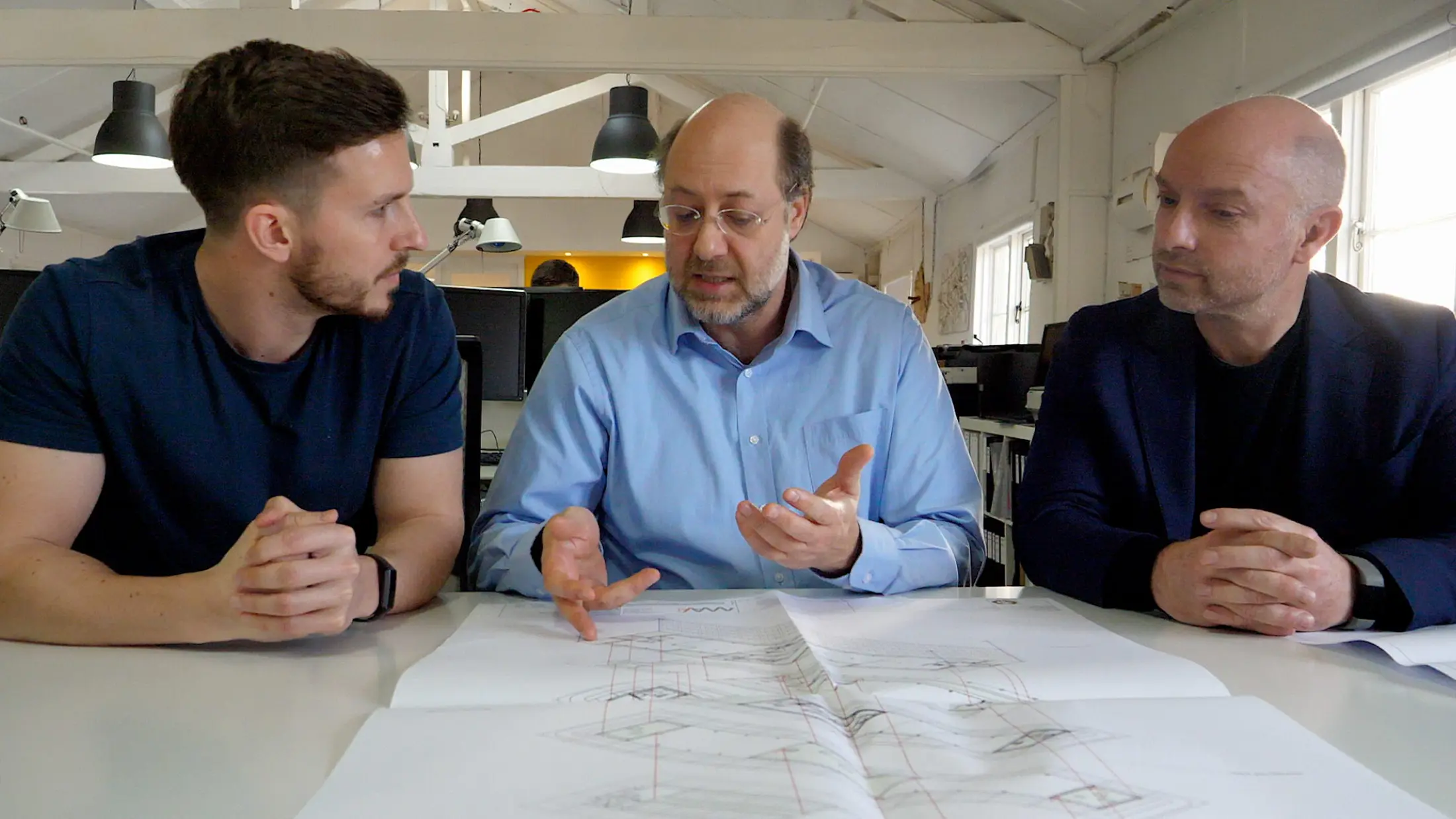 Three men in a meeting