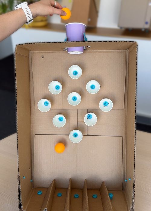 Cardboard Makedo table-top Plinko arcade game with balls dropping