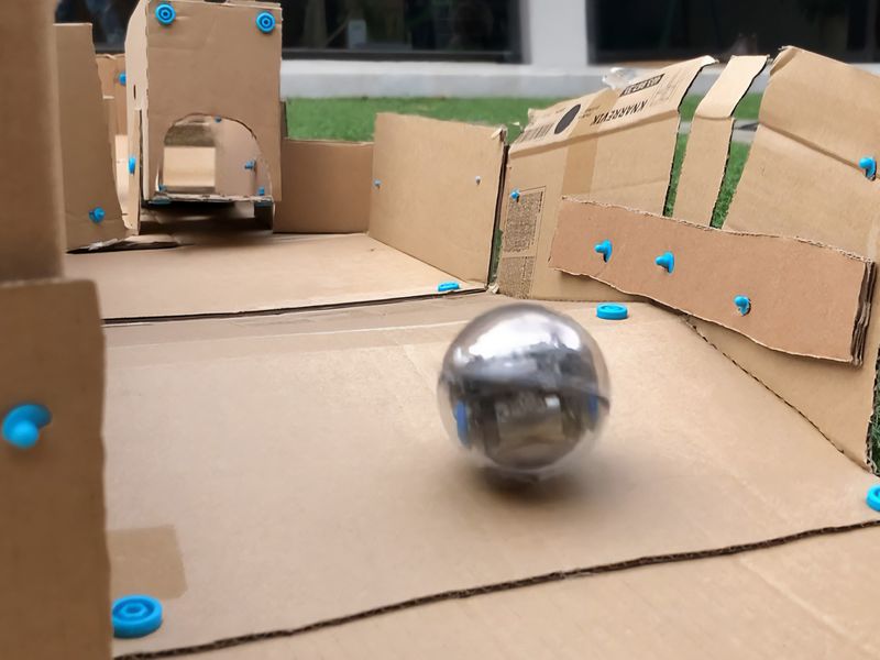 Sphero robot racing along a cardboard Makedo track
