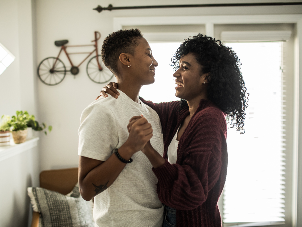 lesbian couple dancing in kitchen