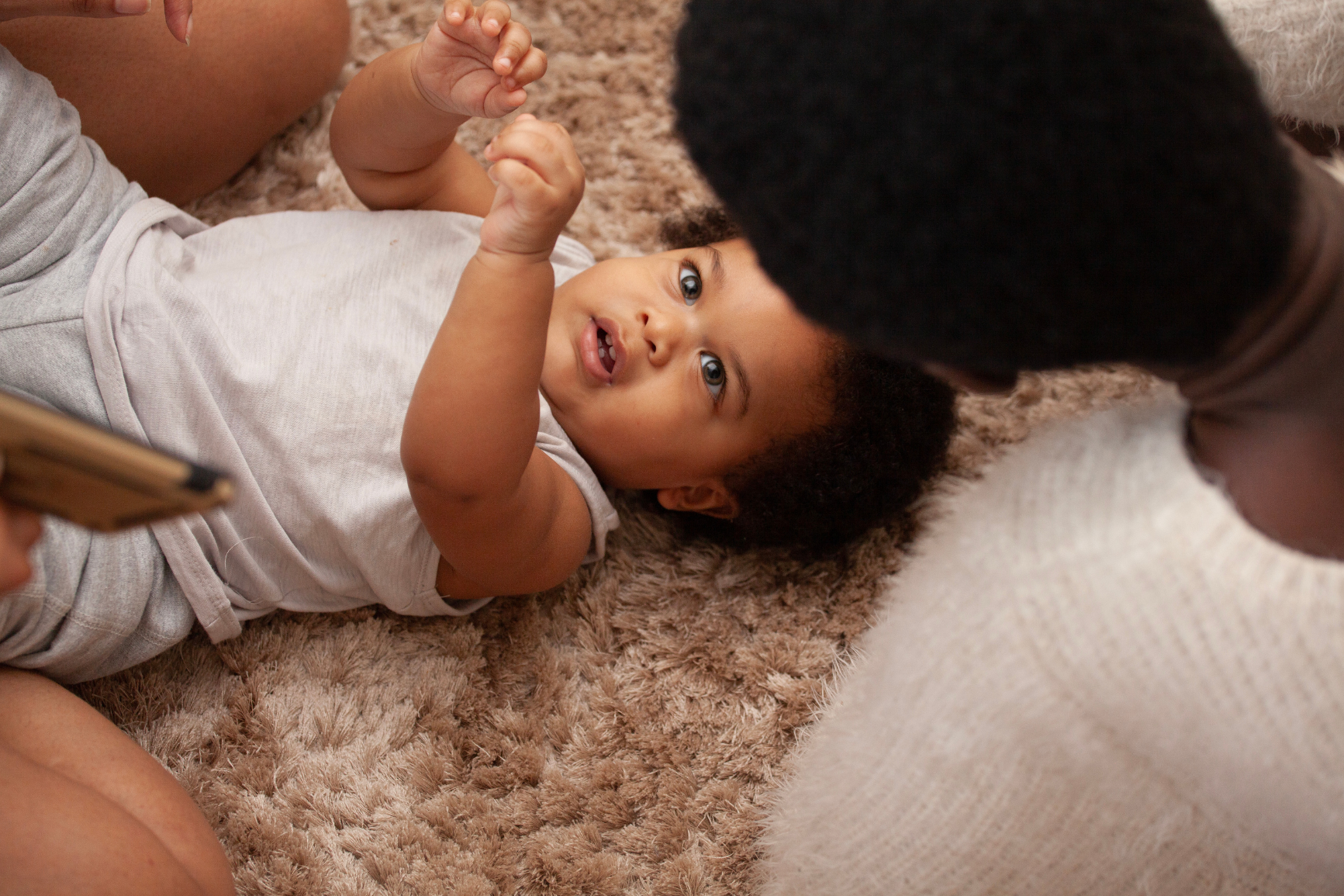 baby looking at mother