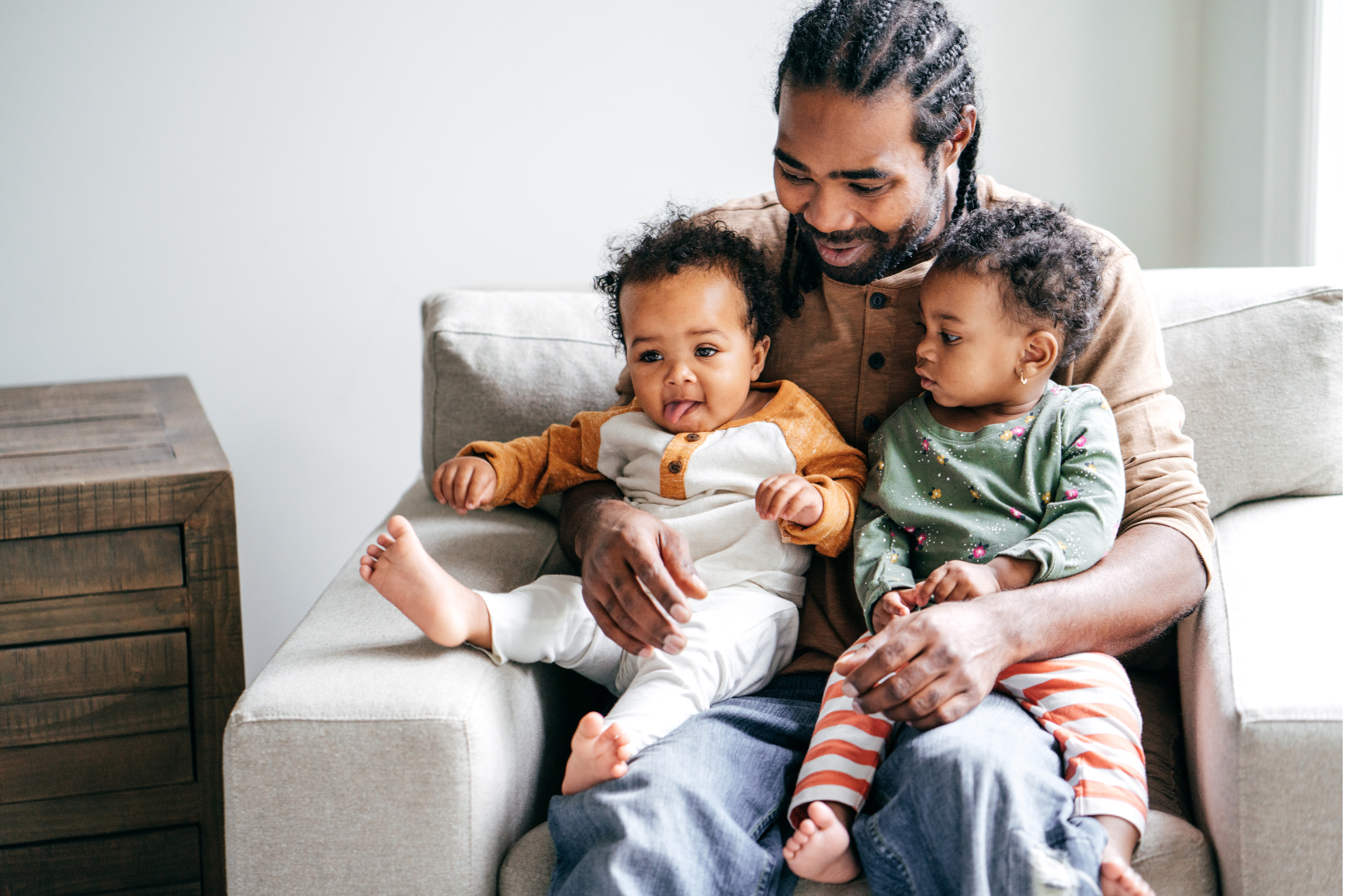 father with two children on lap