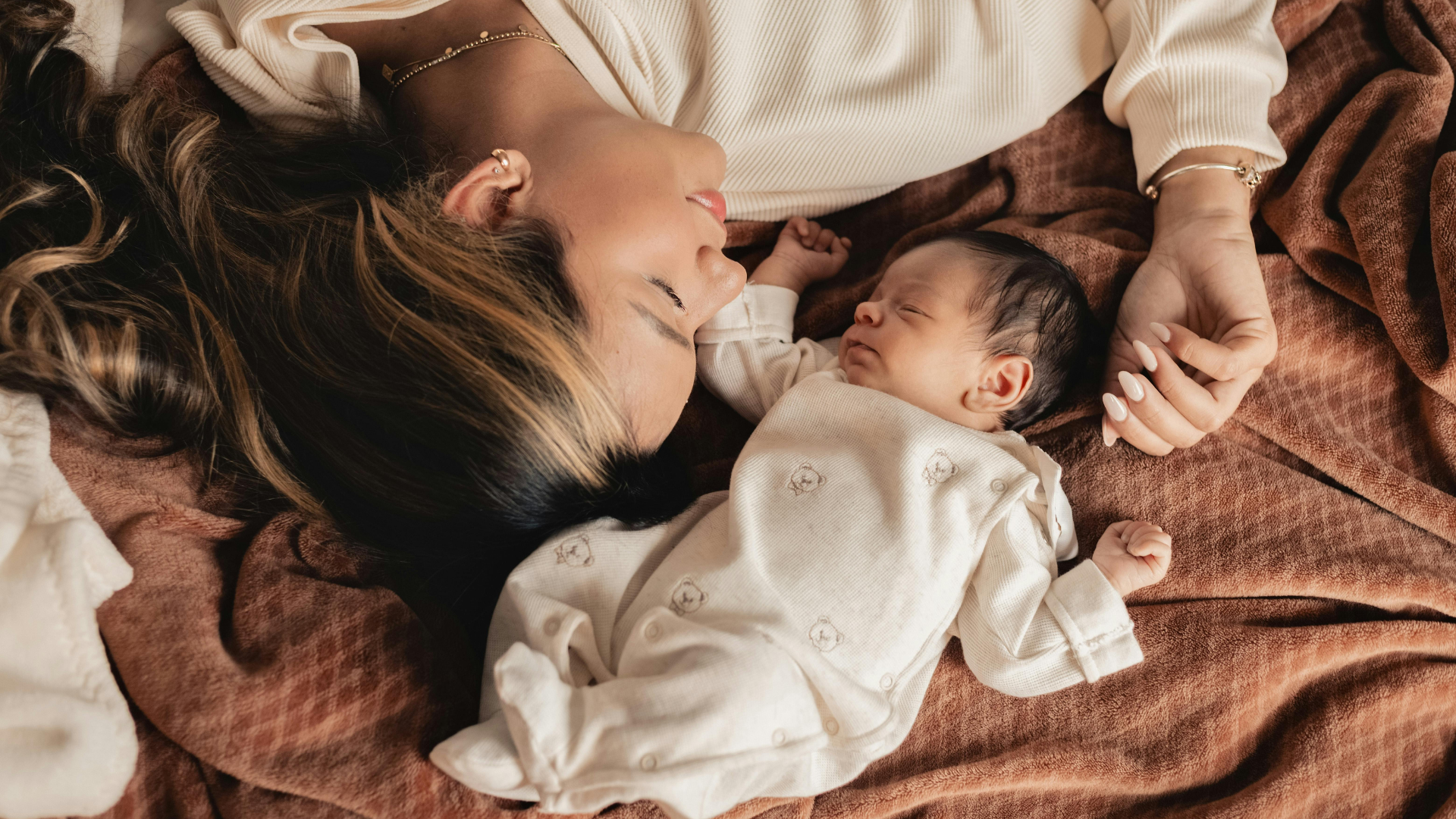 mother and baby resting in bed