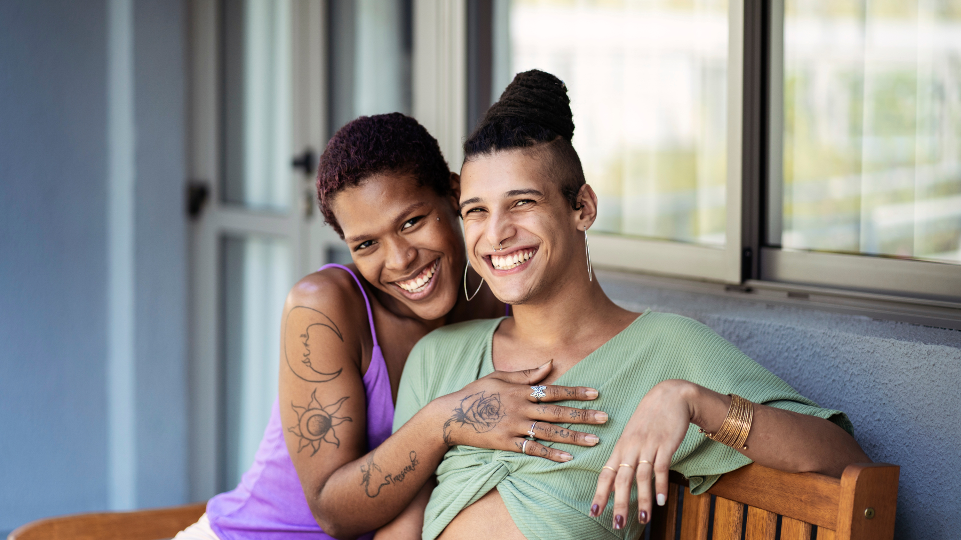 Happy LGBTQ+ couple embracing and smiling