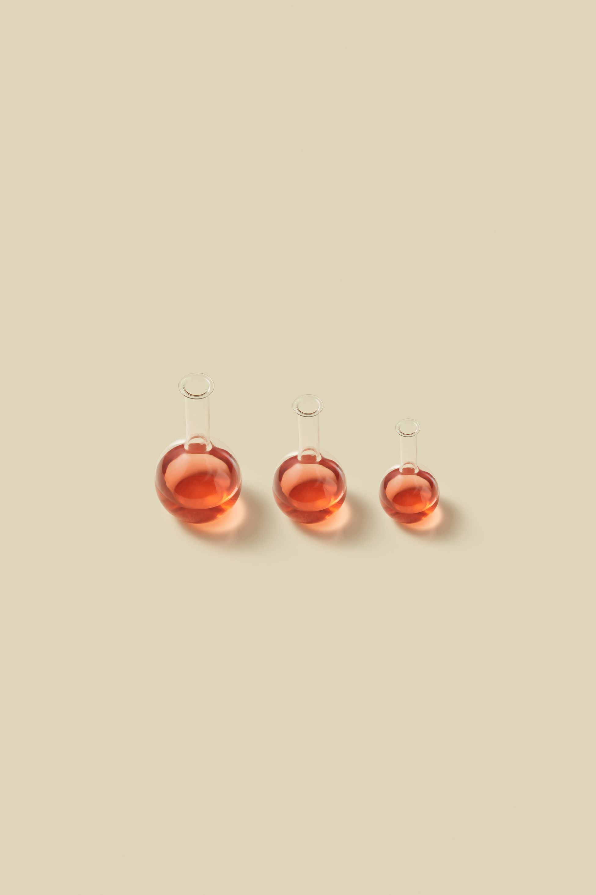round vials of reddish liquid