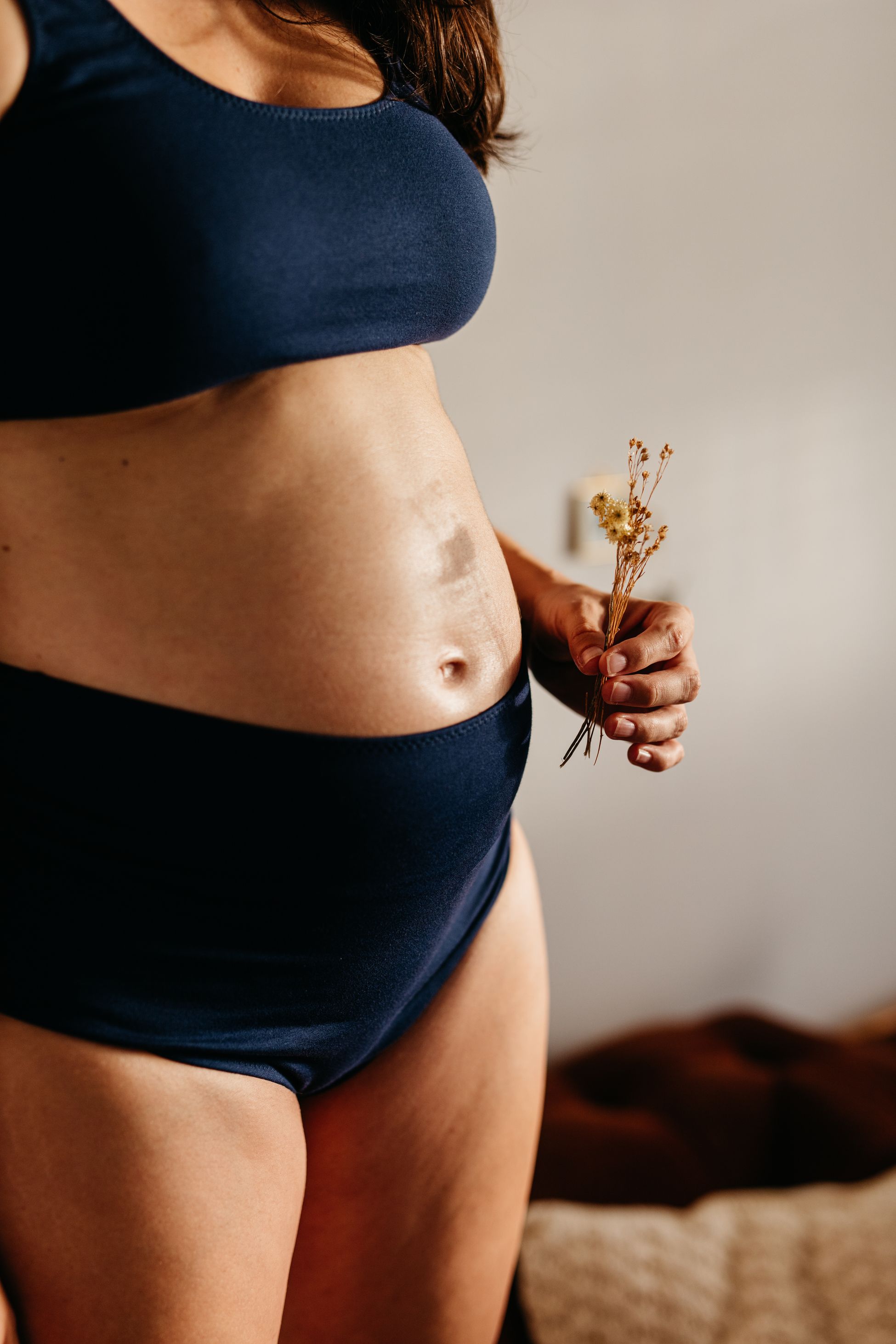 A pregnant woman holding flowers