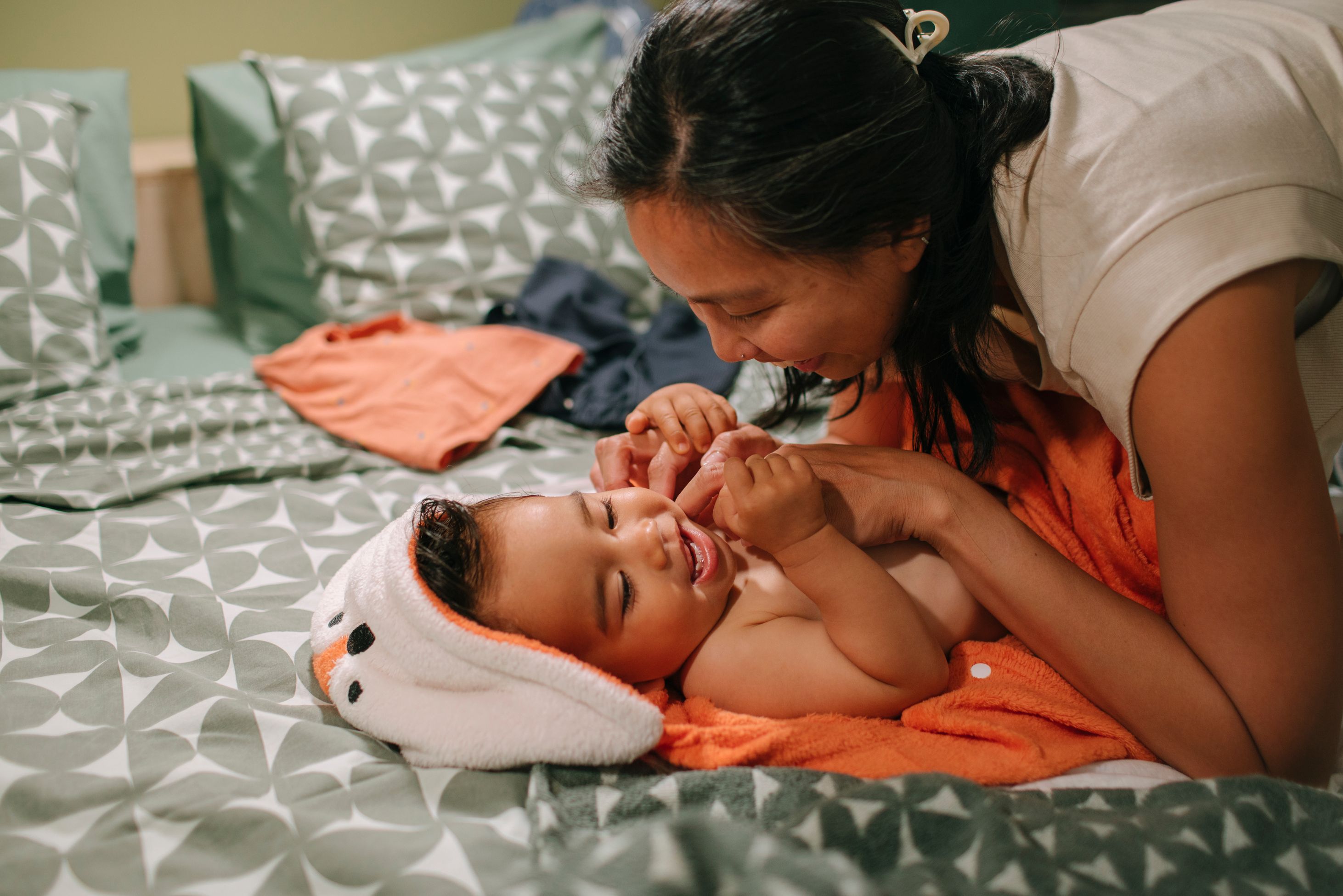 mother playing with child after taking a bath