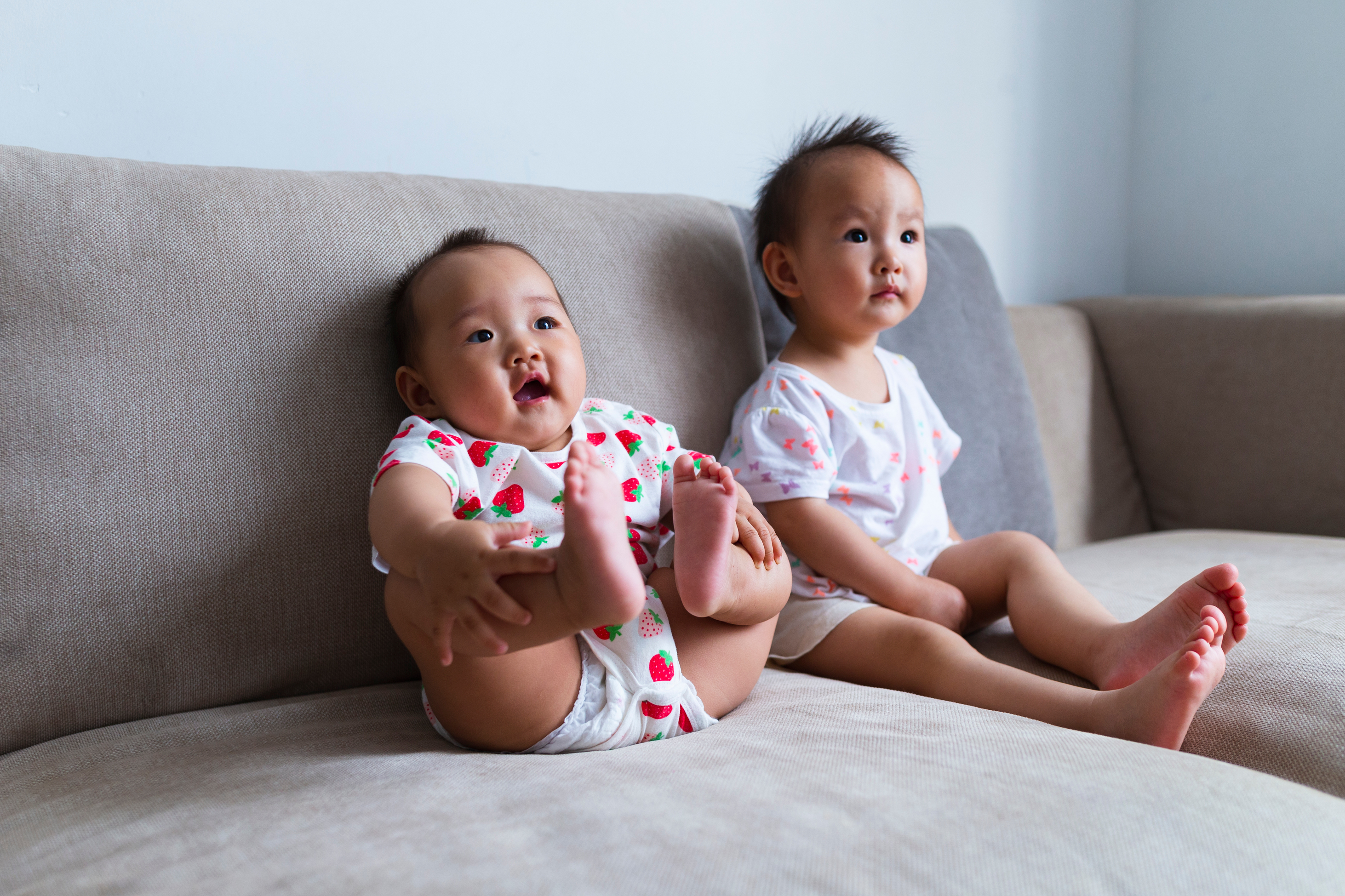 Toddler and baby sitting together