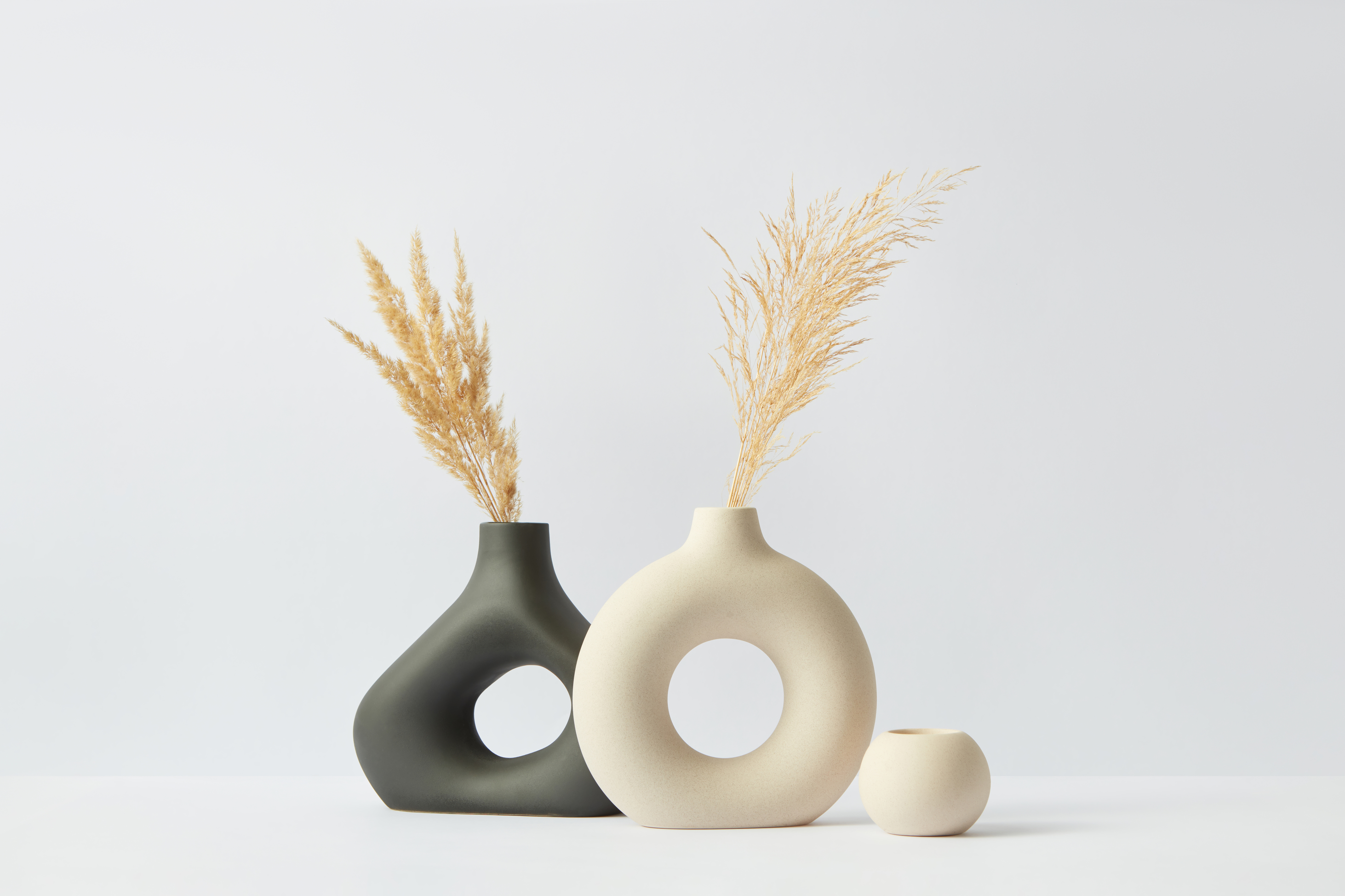 two vases with a smaller vase next to them
