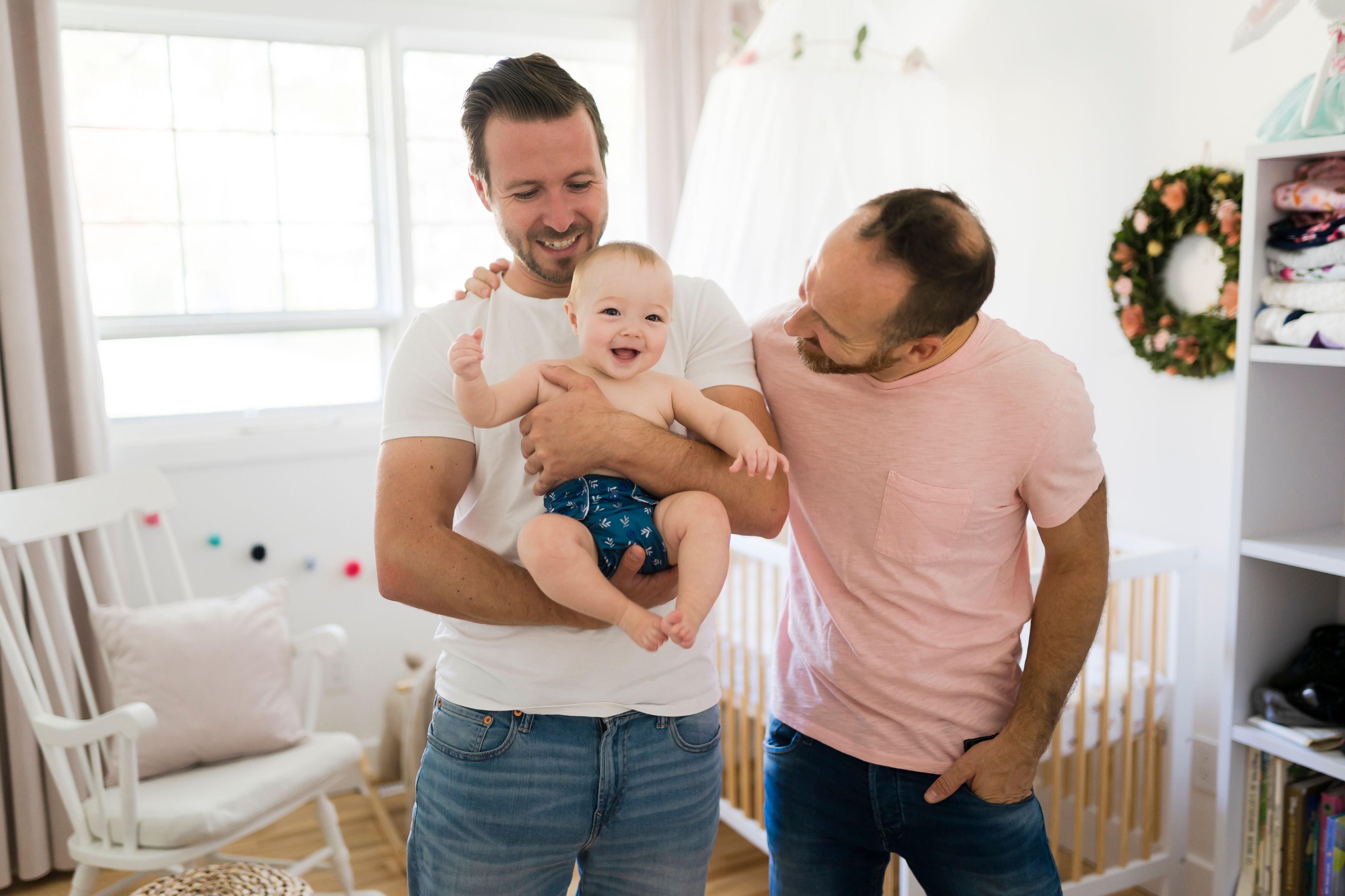 Two fathers with their baby