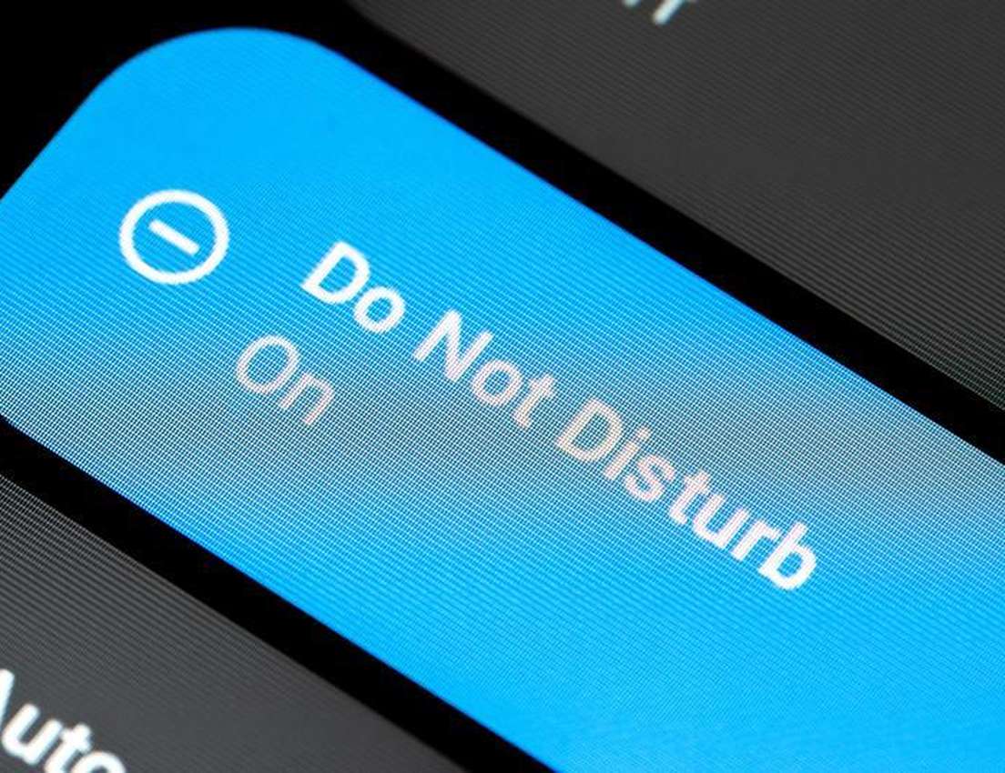 Blue 'Do Not Disturb On' toggle with a minus icon, showing screen pixels on a dark background.