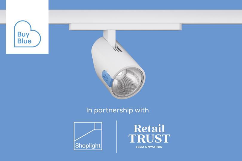 White track light with "Retail Trust" blue label, "Buy Blue" logo, and "Shoplight" and "Retail Trust" partnership logos on a blue background.