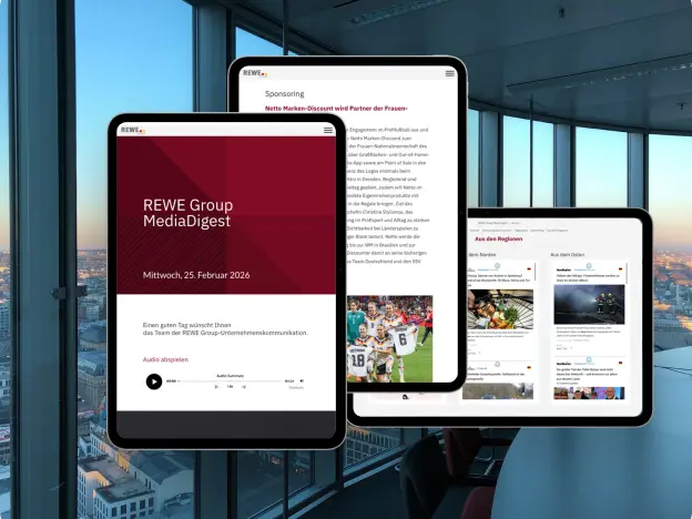 Three tablets display different pages of the REWE Group.