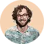 Smiling man with curly hair and glasses