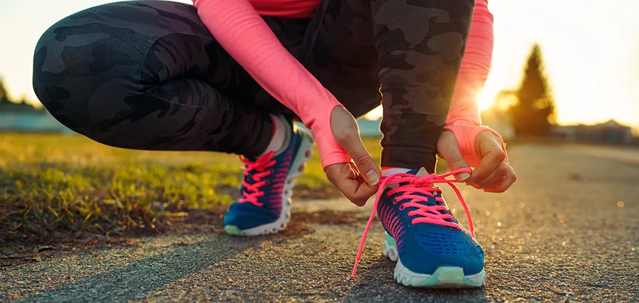 Runner tying shoe laces