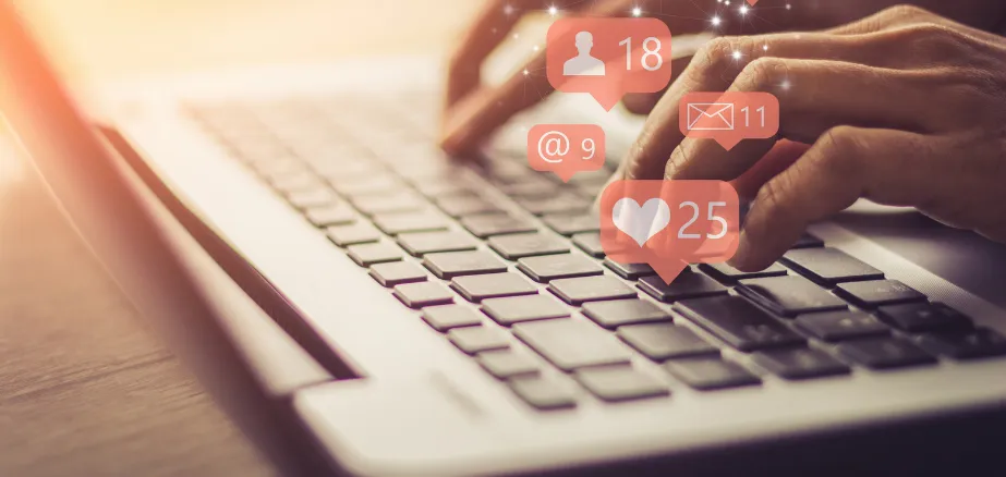 Writing social media posts on a laptop