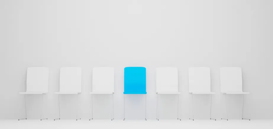 One single blue chair in a row of white chairs