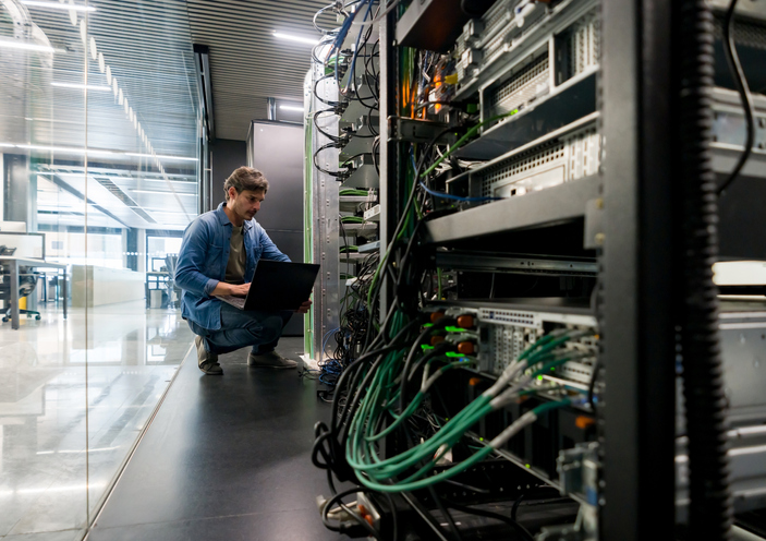 person working on server to avoid cyber attack