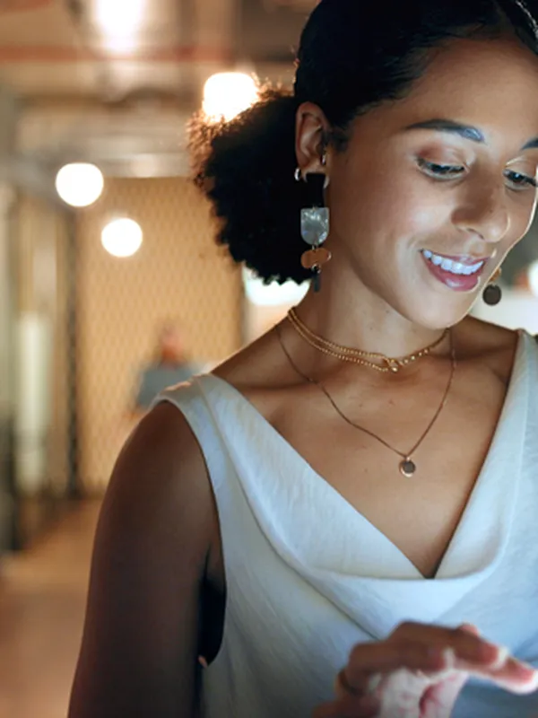 woman smiling looking at playbook on a tablet.
