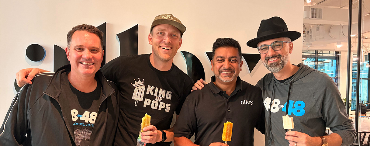 Alloy CEO Raj Choudhury smiling with community partners