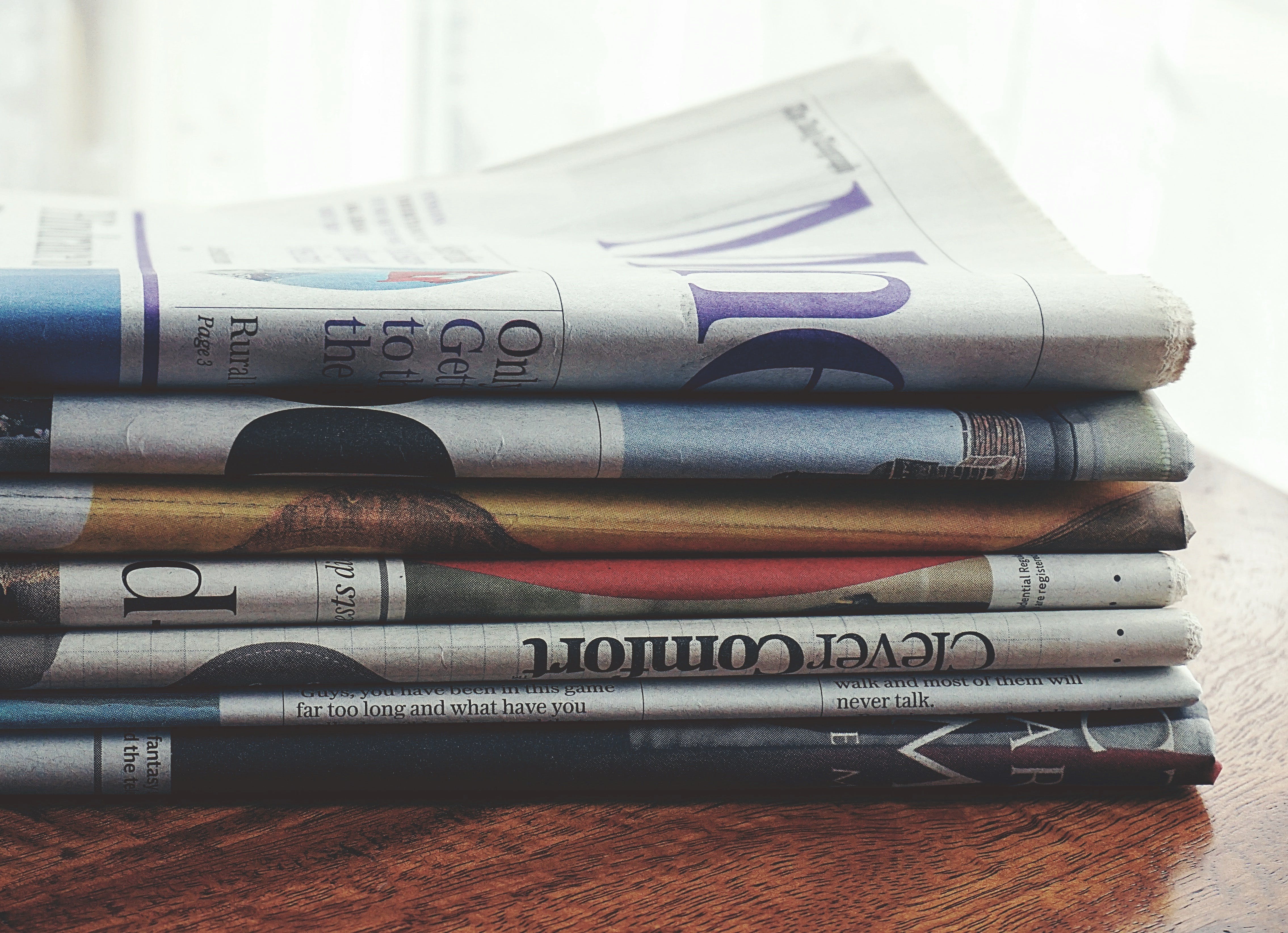 stack of newspapers on top of a table