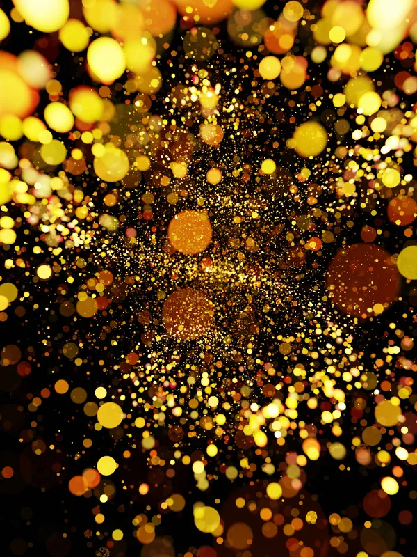 A burst of glowing golden lights scattered on a dark background, creating a dynamic and festive atmosphere.