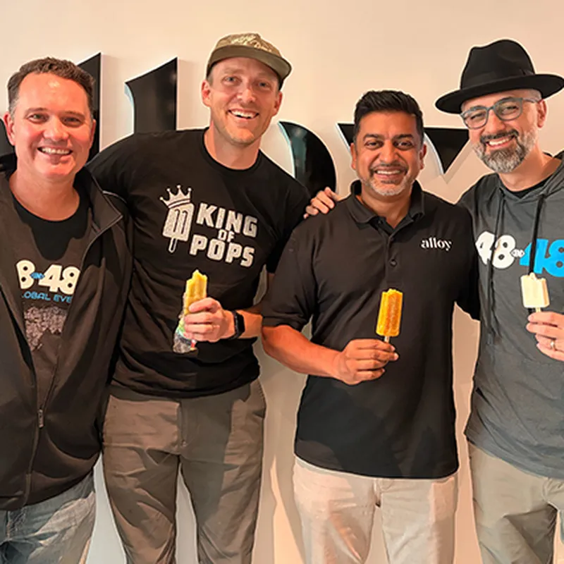 Alloy CEO Raj Choudhury smiling with community partners