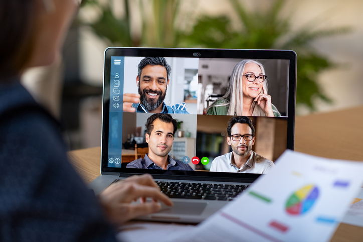 a laptop that a zoom meeting on the screen