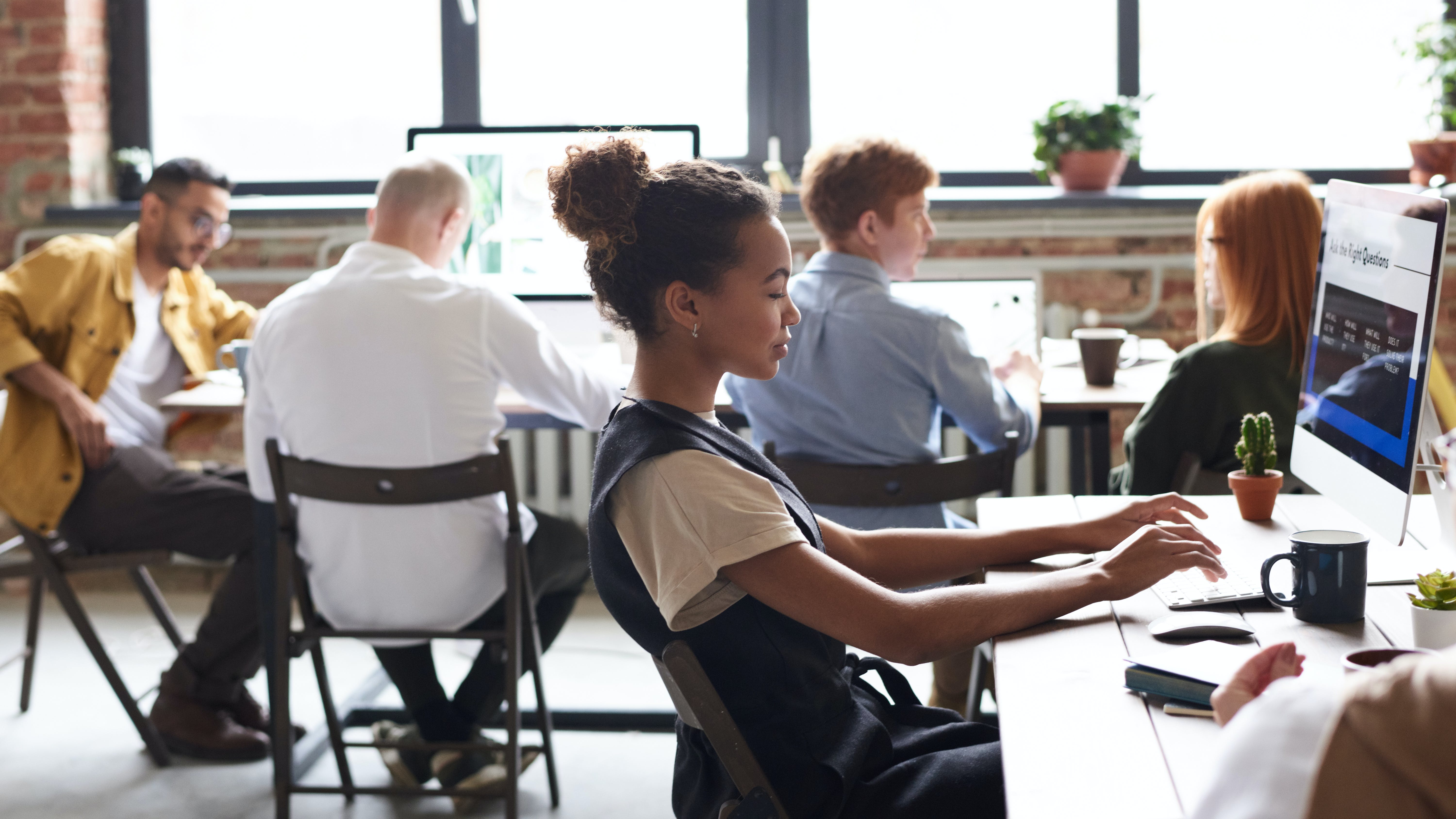 people in a marketing office working at computers