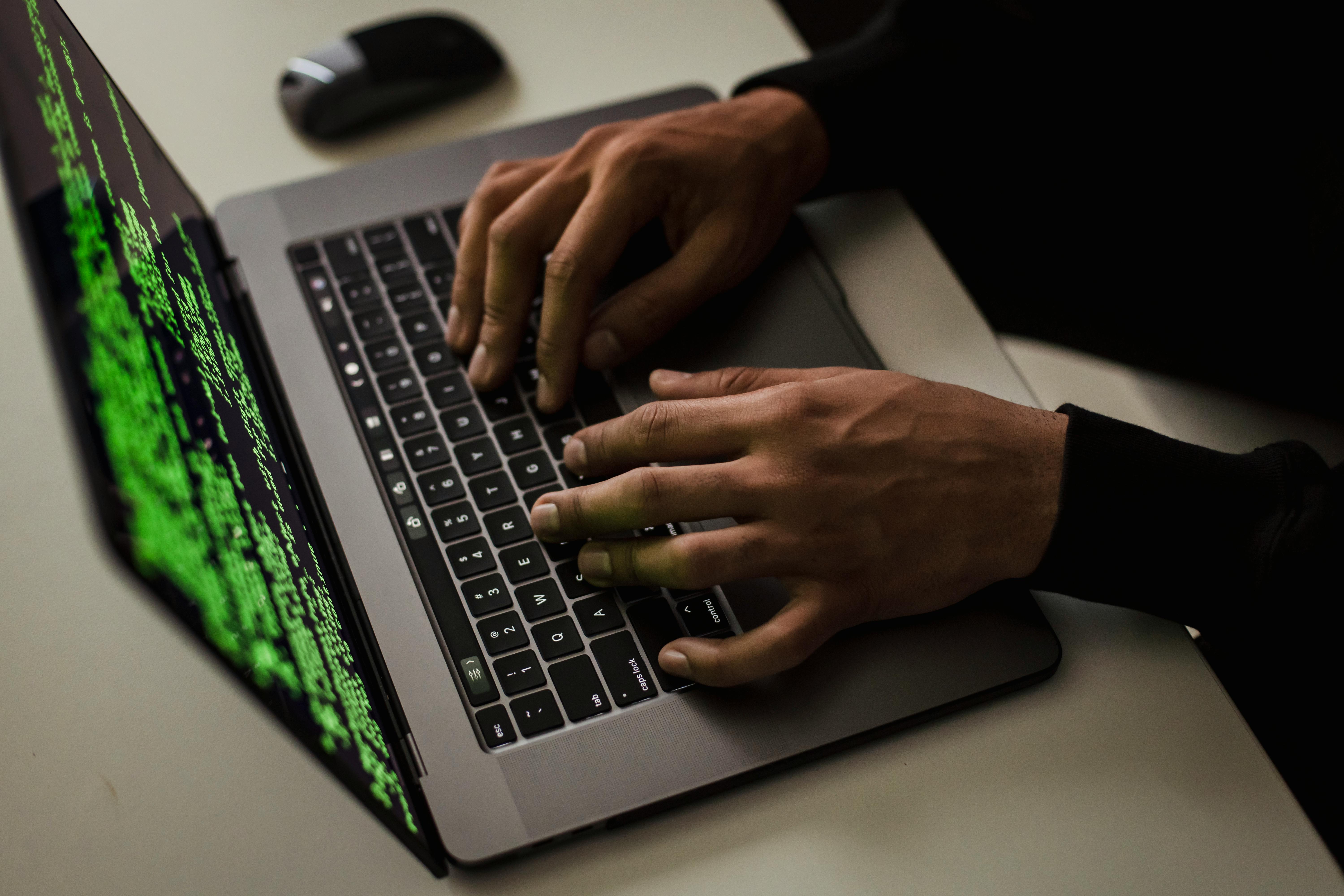close up of someone on a computer hacking into something