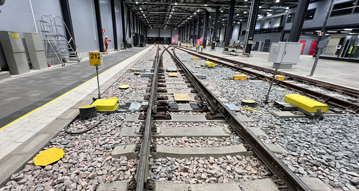 Railway tracks with a switch inside of a station.