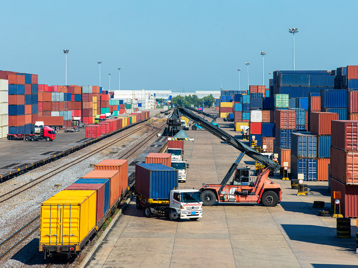 Containers being loaded at a rail freight terminal.