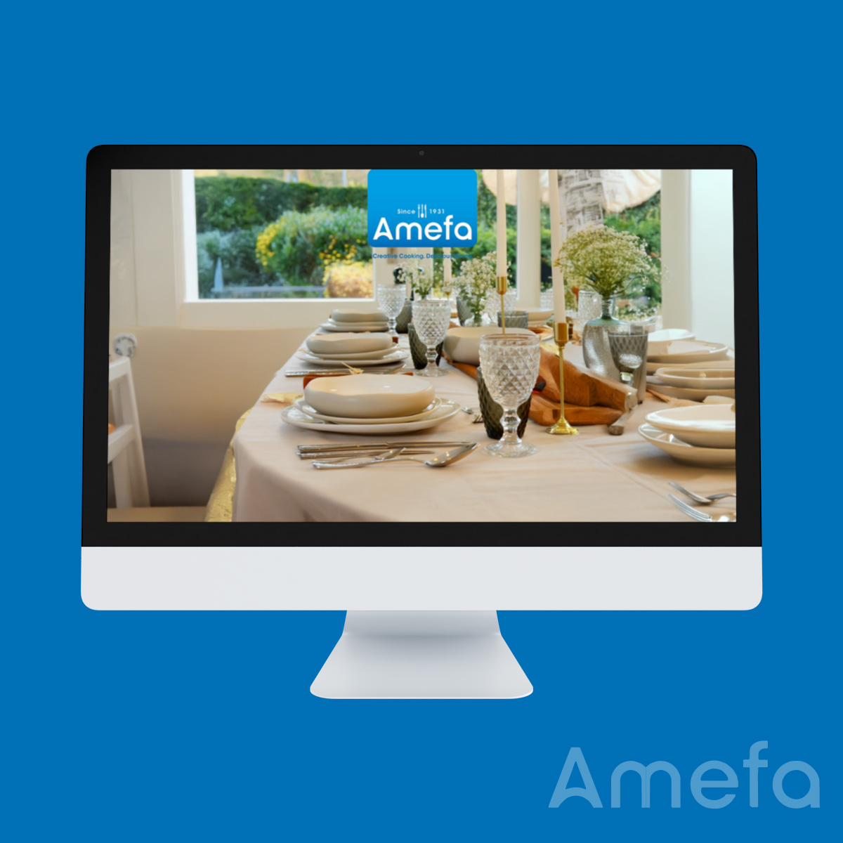 Elegant dining table set with plates, glasses, and flowers on a screen with "Amefa" logo; computer monitor against a blue background.