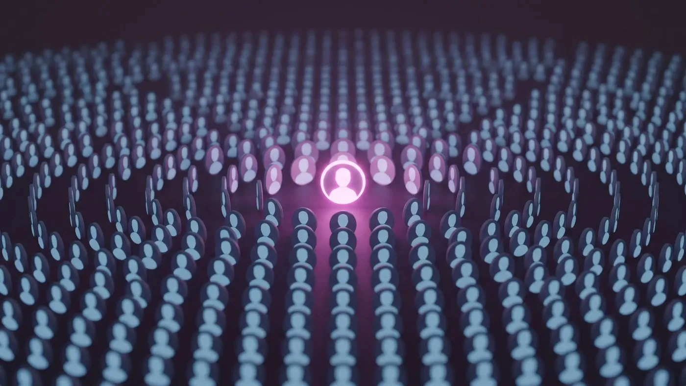 Illustration of a crowd of identical profile pictures with one glowing pink profile standing out