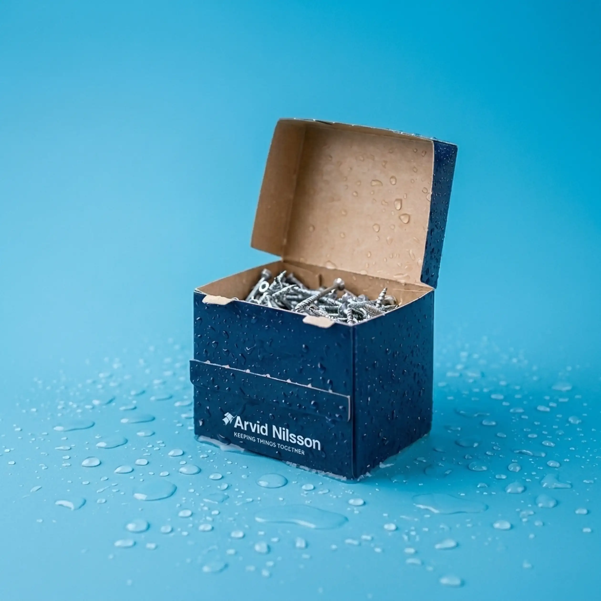 A blue, open cardboard box labeled "Arvid Nilsson" contains screws, with water droplets on the box and surface against a blue background.