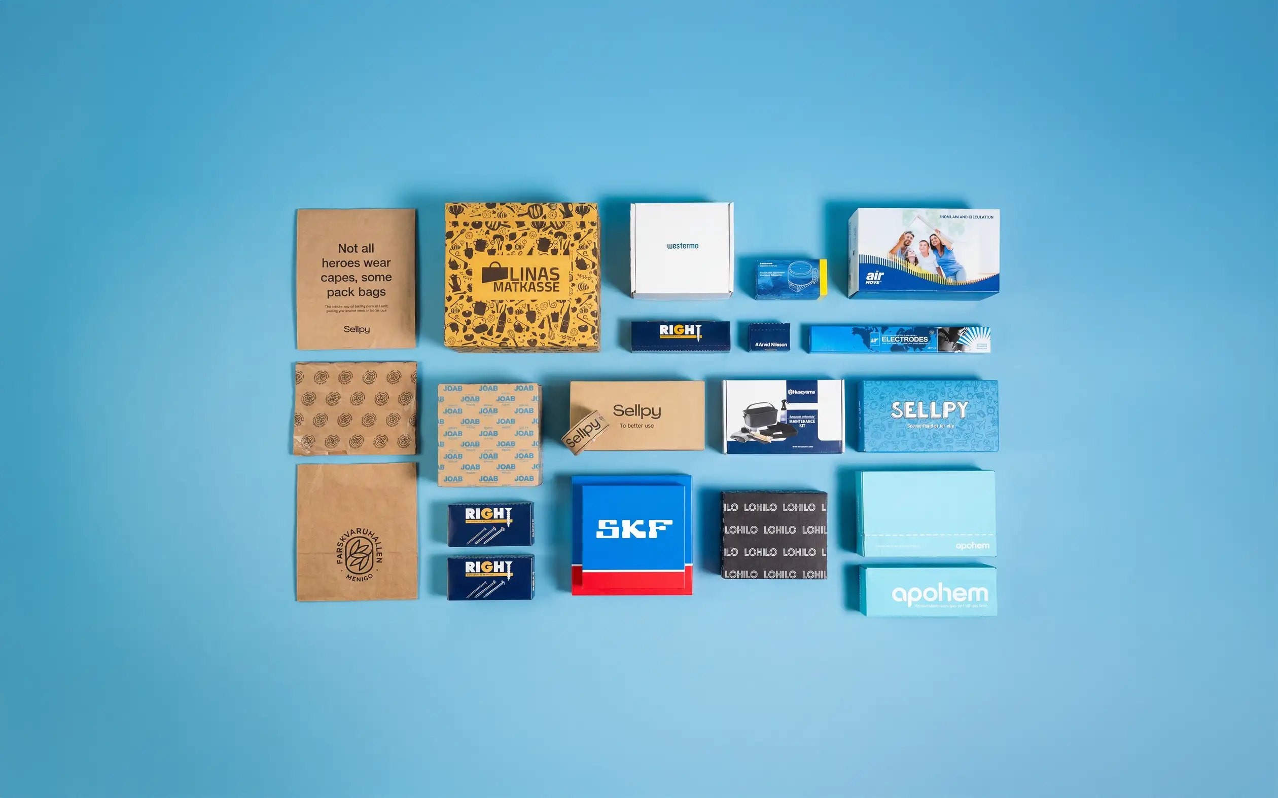 A variety of colorful packaging boxes and paper bags are neatly arranged on a blue background.