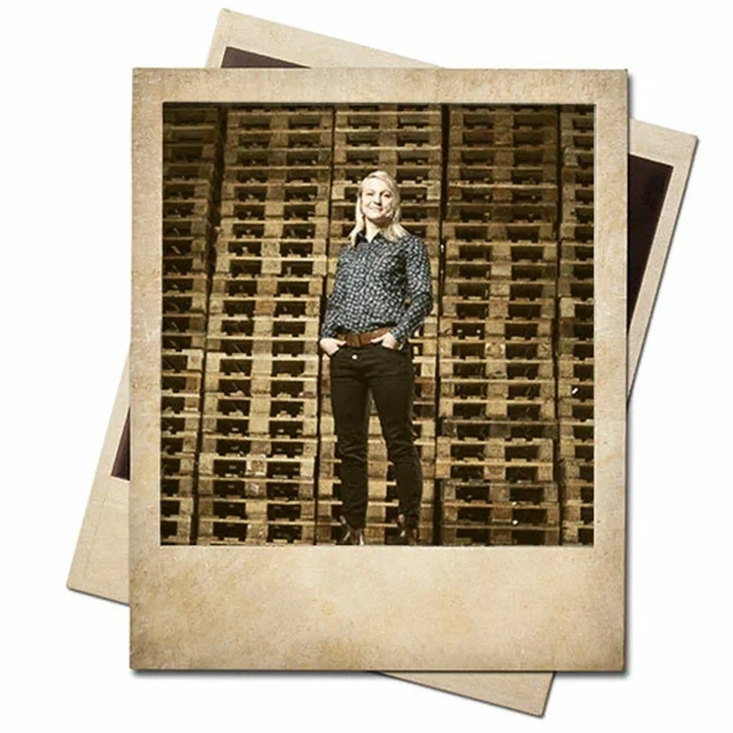 A person stands confidently in front of a large stack of wooden pallets. The photo has a vintage polaroid style.