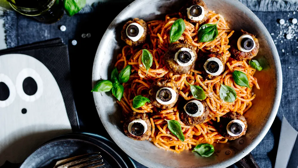 Halloween Spaghetti mit Basilikum und Augen geformt aus Oliven